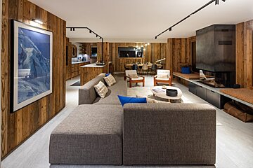 A living room with a couch and a picture on the wall