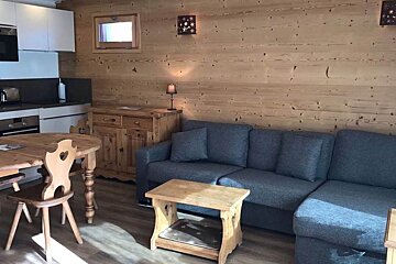 A living room with a couch a table and chairs