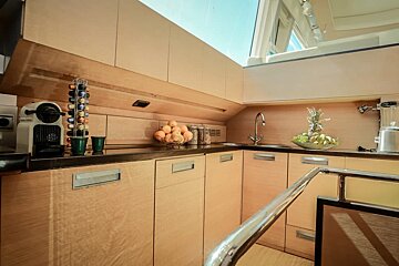 A kitchen with wooden cabinets and a nespresso machine