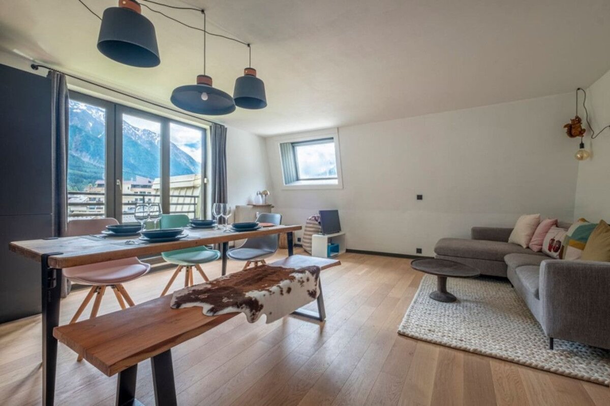 A living room with a table and chairs and a couch