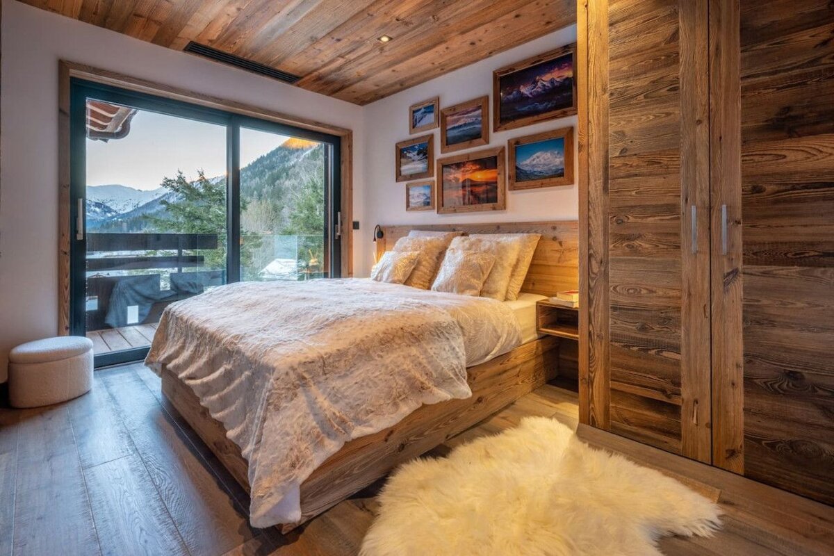 A bedroom with a bed and pictures on the wall