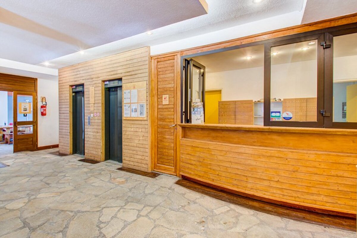 A wooden building with elevators and a counter