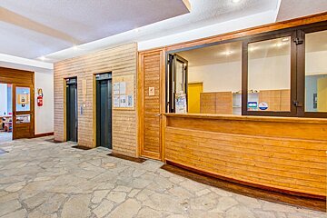 A wooden building with elevators and a counter