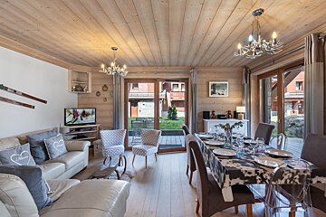 A living room with a couch a table and chairs