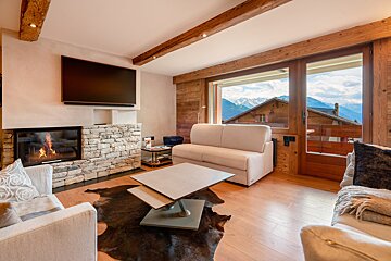 A living room with a fireplace and a flat screen tv