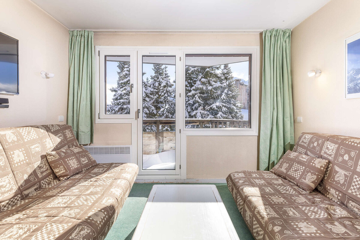 A living room with two couches and a television