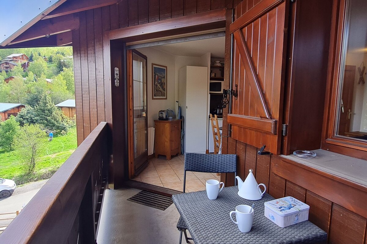 A balcony with two cups and a teapot on it