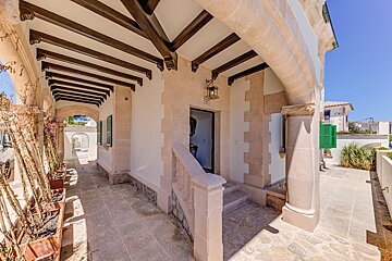 A house with a staircase leading up to the front door
