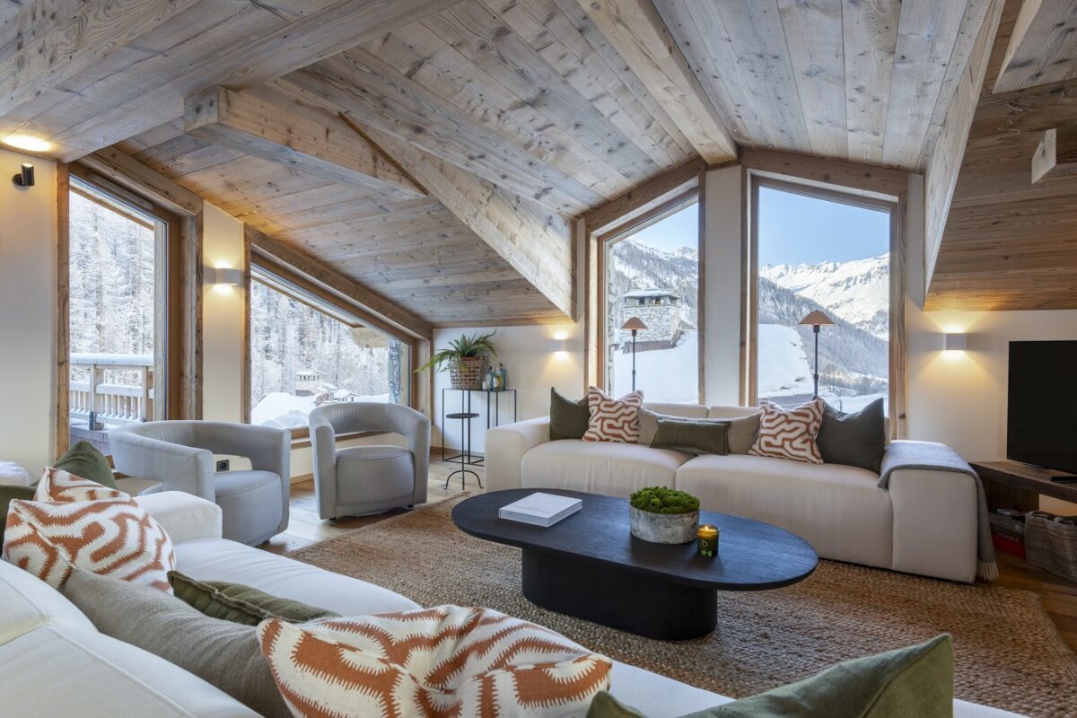 A living room with a couch and two chairs