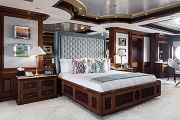 A bedroom with a large bed and two nightstands