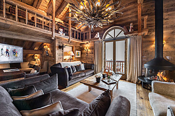 A living room with a fireplace and a flat screen tv