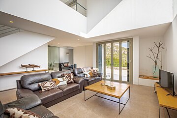 A living room with two leather couches and a wooden coffee table