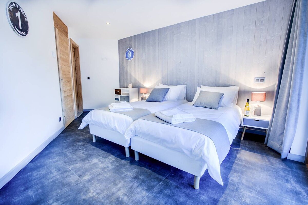 A bedroom with two beds and a sign on the wall that says number 1