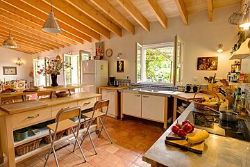 A kitchen with a table and chairs and a refrigerator