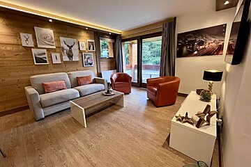 A living room with a couch and two chairs