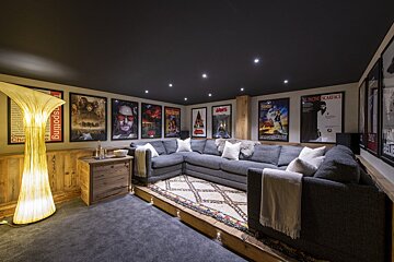 A movie poster for jaws hangs above a couch