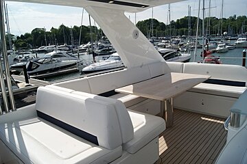 A boat with a table and benches is docked in a marina