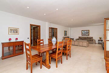 A living room with a dining table and chairs
