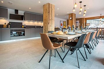A kitchen and dining area with a table and chairs