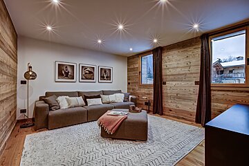A living room with a couch and a rug
