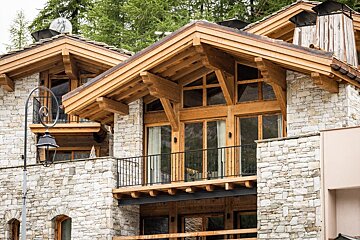 A large stone building with a wooden roof and a balcony