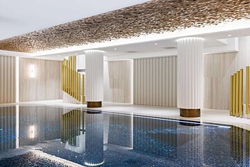 A luxurious indoor swimming pool featuring a shimmering gold textured ceiling, fluted white columns, and gold accents. Modern opulent design.