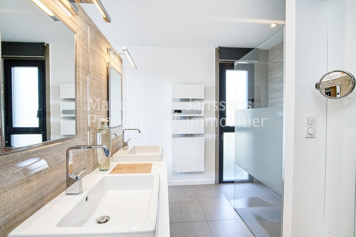 A bathroom with two sinks and a mirror that says made in provence