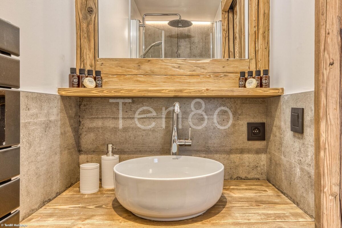 A bathroom with a sink and a mirror with the number 80 on the wall