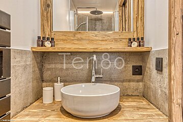 A bathroom with a sink and a mirror with the number 80 on the wall