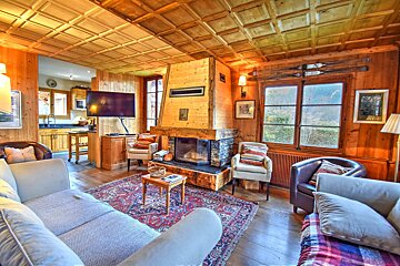 A living room with a fireplace and a flat screen tv