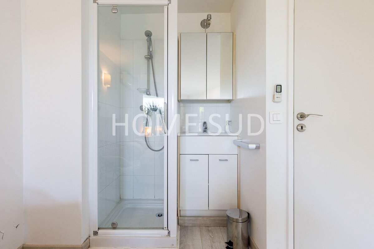 A bathroom with a sink and a shower that says home sude on the door