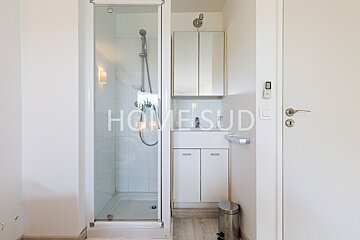 A bathroom with a sink and a shower that says home sude on the door
