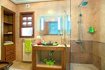 A bathroom with a sink and a walk in shower