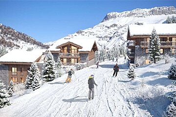 A group of people skiing down a snow covered path