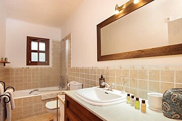 A bathroom with a sink toilet and bathtub