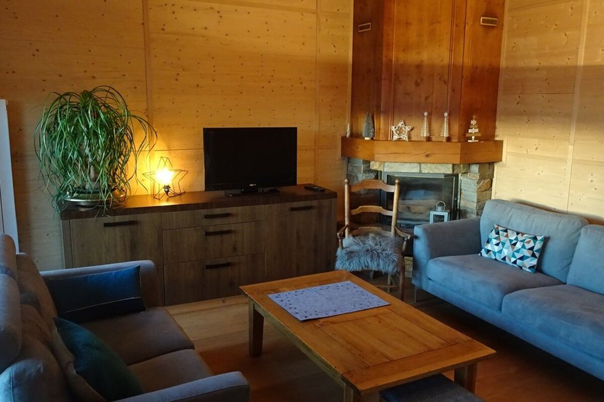 A living room with a couch and a flat screen tv