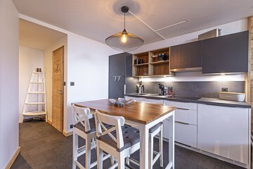 A kitchen with a bread box on the counter