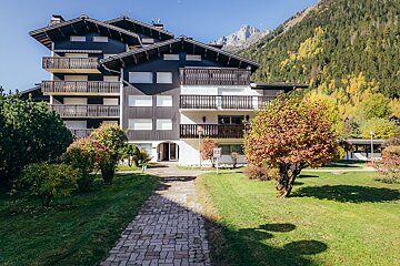 A snowy building with a mountain in the background
