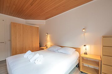 A bedroom with a bed and two nightstands