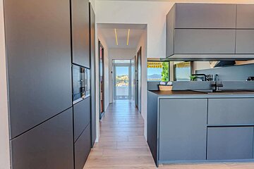 A kitchen with black cabinets and a sink
