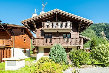 A house with a balcony and a satellite dish on top of it