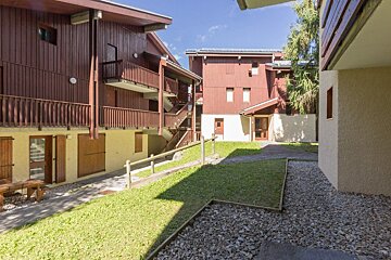 A row of wooden buildings with stairs leading up to them