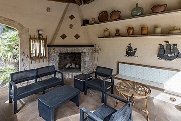 A room with a fireplace and a table and chairs