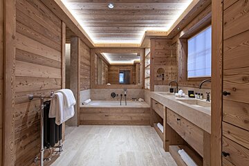 A bathroom with a bathtub and two sinks