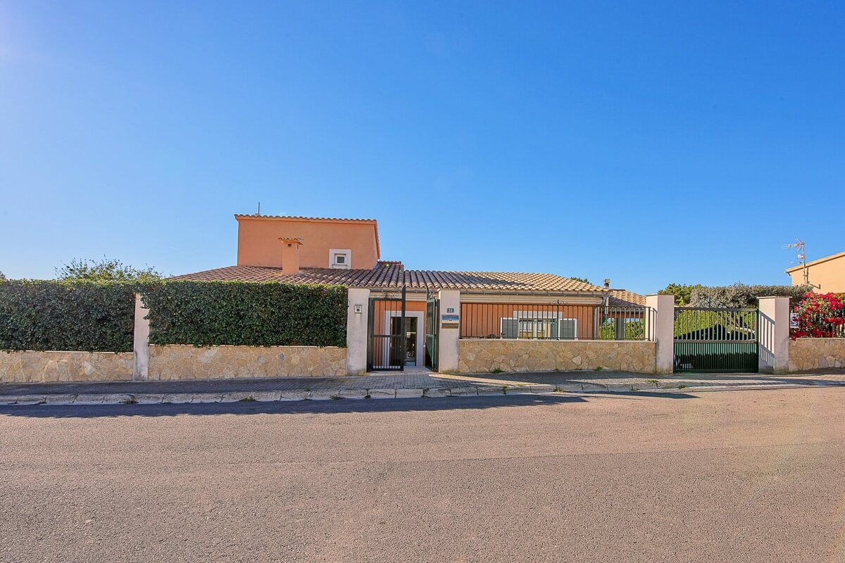 A house with a fence and a sign that says ' a ' on it
