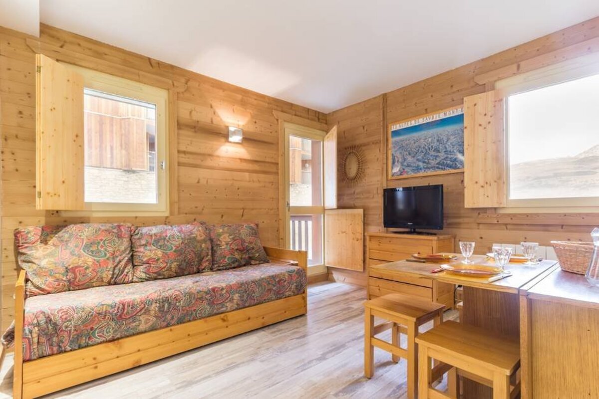 A living room with a couch and a flat screen tv