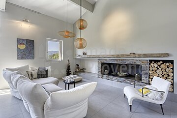 A living room with a fireplace and the word oven on the wall