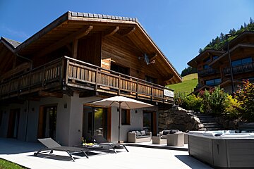 A house with a sign on the side that says chalet