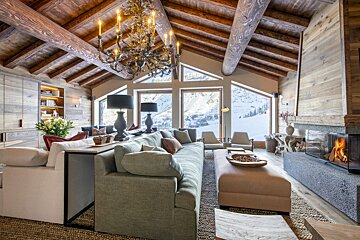 A living room with a large couch and a fireplace