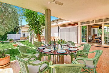 A table with plates and a bottle of wine on it